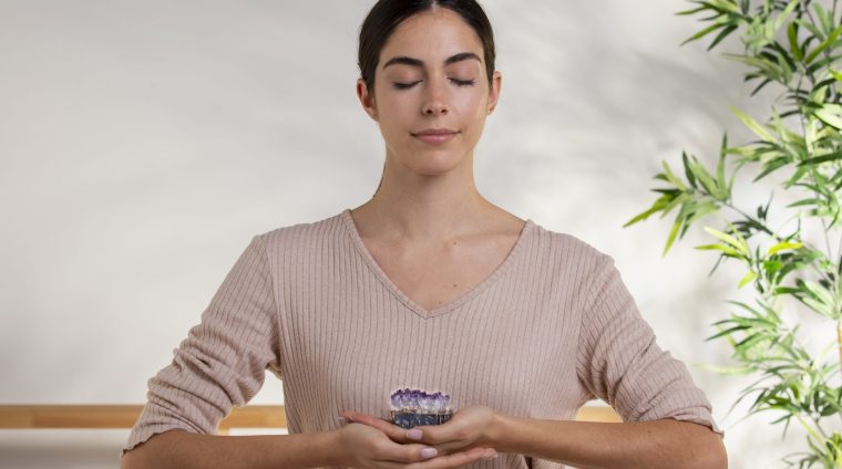 medium-shot-smiley-woman-holding-purple-crystal