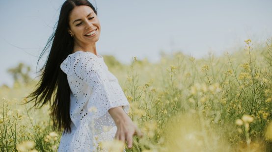 Pretty young woman in the rapeseed field